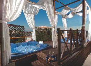 a jacuzzi tub on a deck with a view at Grand Hotel Savoia in Genoa