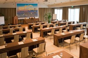 a large room with tables and chairs in it at Grand Hotel Savoia in Genoa