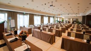 a large banquet hall with tables and chairs at Grand Hotel Savoia Genova, Curio Collection by Hilton in Genoa +149 photos
