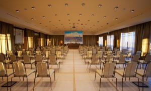 a large room with chairs and a stage in it at Grand Hotel Savoia in Genoa