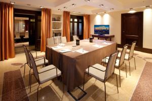 a conference room with a long table and chairs at Grand Hotel Savoia in Genoa