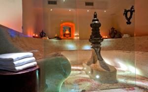 a bathroom with a bath tub with a glass shower at Grand Hotel Savoia in Genoa