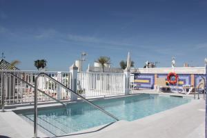 a swimming pool with a white fence around it at Hotel Puerta del Mar - Adults Recommended in Nerja