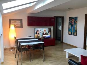 a living room with a table and a tv at Casa Nika in Riva del Garda