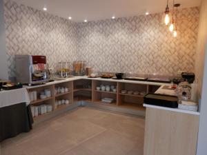 a kitchen with a counter in a restaurant at Hotel Puerta del Mar - Adults Recommended in Nerja