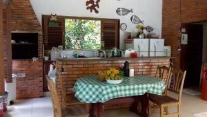 a kitchen with a table with a bowl of fruit on it at Amazon Hostel & Eventos in Iranduba