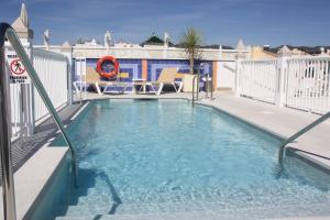 a swimming pool on the roof of a building at Hotel Puerta del Mar - Adults Recommended in Nerja