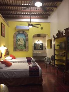 Postel nebo postele na pokoji v ubytování Hotel San Miguel Arcangel