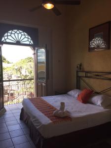 a bedroom with a dummy sitting on a bed at Hotel San Miguel Arcangel in Izamal