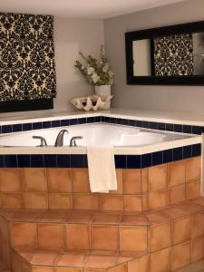 a bath tub with a tile floor and a mirror at Barclay House Bed and Breakfast in Vancouver +128 photos