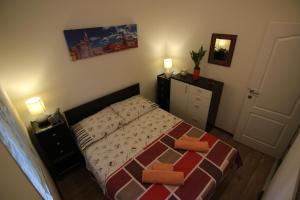 a small bedroom with a bed and a dresser at Zadar Center Apartment in Zadar