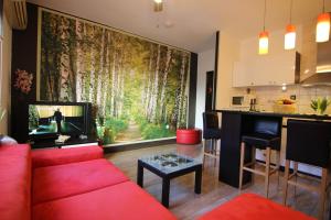 a living room with a red couch and a large painting at Zadar Center Apartment in Zadar