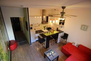 a kitchen and a living room with a red couch at Zadar Center Apartment in Zadar