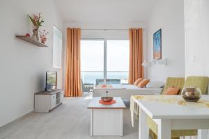 a living room with a couch and a table at Sunset Apartments in Ulcinj