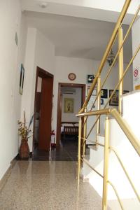 a hallway with a staircase and a living room at Hotel Italia in Tirana