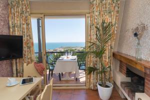 a living room with a view of the ocean at Apartament Cap de Vol in Port de la Selva +4 photos