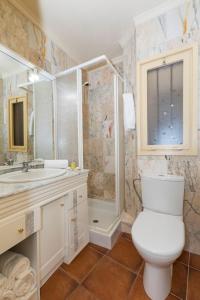 a bathroom with a toilet and a sink and a shower at Apartament Cap de Vol in Port de la Selva