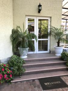 a front door of a house with potted plants at Guest House on Vinogradnaya in Sochi
