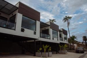 a house with large windows and palm trees at El Refugio in Ensenada