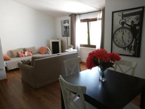 a living room with a table and a couch and a clock at B&B La Casa Bianca in Fossacesia +31 photos