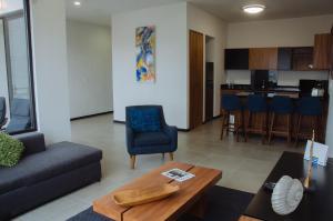 a living room with a couch and a table at El Refugio in Ensenada