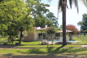 a house with a palm tree in front of it at Los Nogales de Yerua in Calabacillas