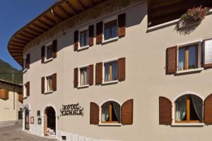 a building with a window and some windows at Garnì Hotel Tignale, GTSGroup in Tignale
