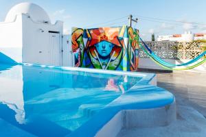 a pool with a colorful chair next to a swimming pool at Valentina Suites by Las Flores Vacation Rentals in Playa del Carmen +21 photos