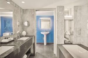 a bathroom with a sink, mirror, and bathtub at Andaz West Hollywood-a concept by Hyatt in Los Angeles