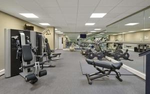 a gym with several rows of treadmills and machines at Hyatt Place London Heathrow Airport in Hillingdon