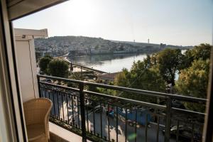 a balcony with a view of a river at Zoumboulis Rooms in Mytilene