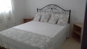 a bedroom with a large white bed with white pillows at Villa FRANCOISE in Pereybere +15 photos