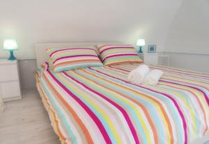 a bed with two towels and two pillows on it at Hello Gaeta Apartment in Gaeta
