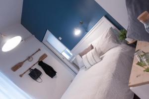 a bedroom with a white bed and a mirror at Matinee Rooms in Mattinata
