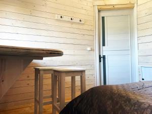 a bedroom with a bed and two stools at Stare Selo in Kolochava +17 photos