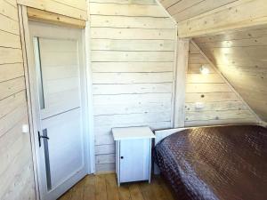 a small bedroom with a bed and a door at Stare Selo in Kolochava