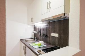 a kitchen with white cabinets and a sink at FREE PARKING, QUIET design flat in the centre in Budapest