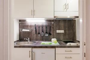 a kitchen with a sink and a counter with utensils at FREE PARKING, QUIET design flat in the centre in Budapest