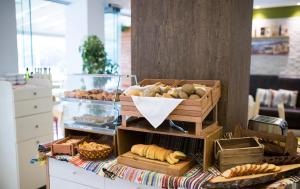 a table topped with lots of different types of bread at Island Boutique Hotel in Rhodes Town