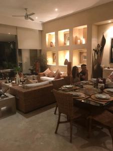 a group of people sitting at a table in a living room at Oceanfront Apartment at Punta Diamante in Acapulco