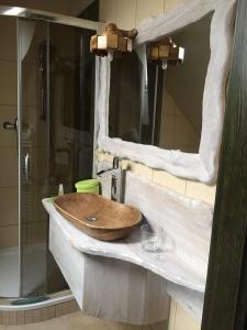 a wooden sink in a bathroom with a shower at Privat pri Hradbach in Levoča