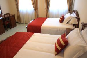 A bed or beds in a room at Albergo Italia