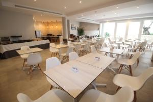 a dining room with tables and chairs and a cafeteria at Hotel Puerta del Mar - Adults Recommended in Nerja