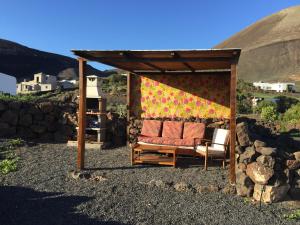 a couch sitting under a gazebo at Casa Rural los Ajaches in Yaiza