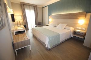 a hotel room with a large bed and a window at Hotel Puerta del Mar - Adults Recommended in Nerja