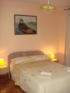 ein Schlafzimmer mit einem Bett und einem Wandgemälde in der Unterkunft Apartments Jelicic in Selce