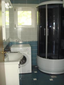 a bathroom with a washing machine and a window at Apartments Jelicic in Selce