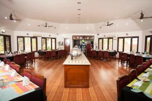 a dining room with tables and chairs in a restaurant at Jungle Safari Resort in Sauraha