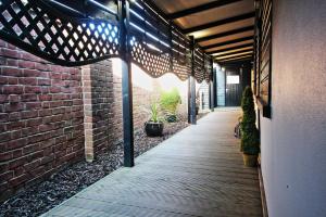 a hallway with a brick wall and a wooden walkway at Star Apartment Ipswich, A Hidden Gem near the Waterfront in Ipswich