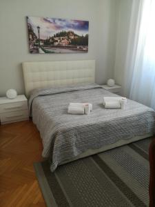 a bedroom with a bed with two towels on it at A casa di Luca in Verona
